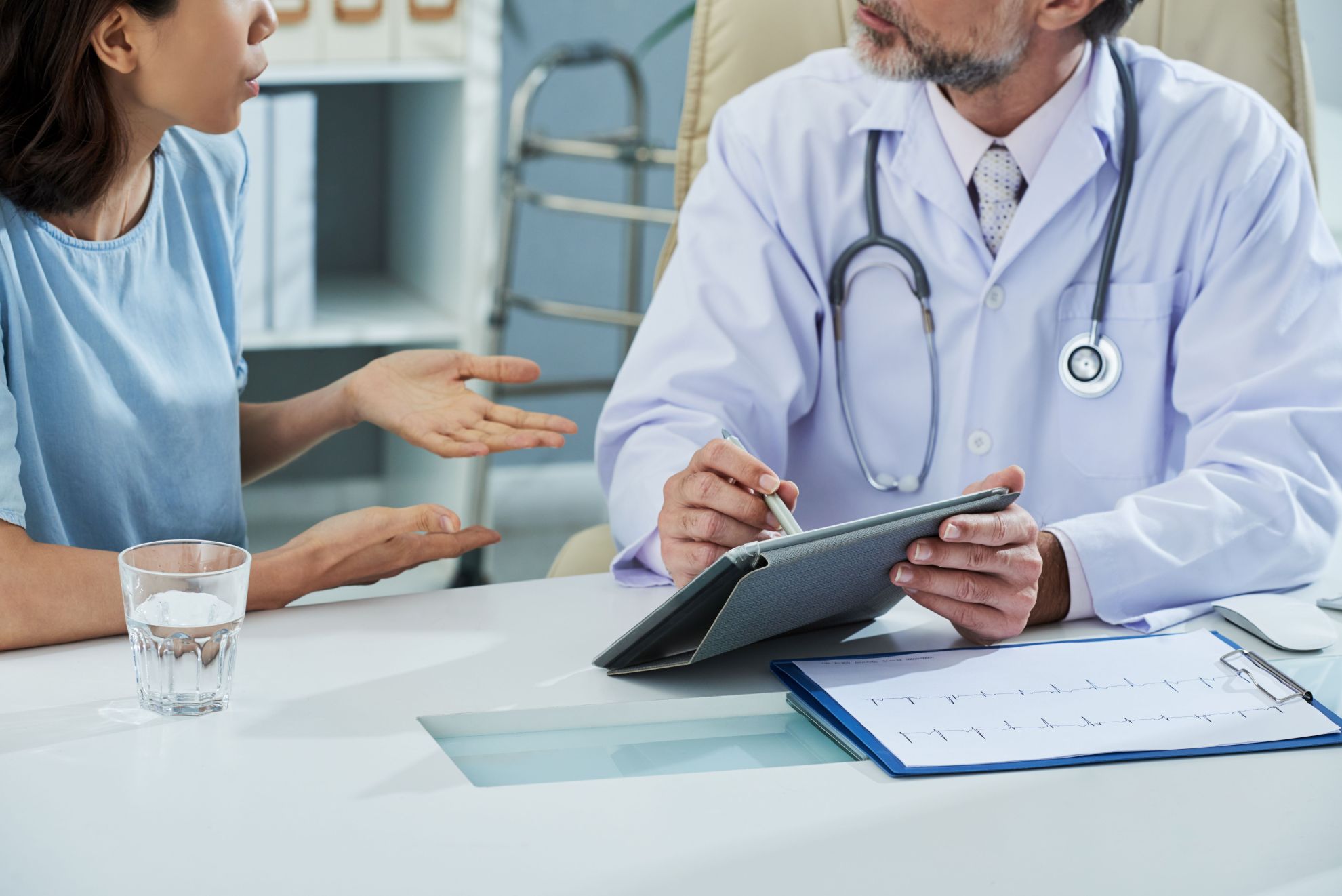 Cropped image of doctor and patient discussing results of tests